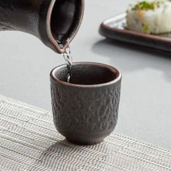 Acopa Heika 1.5 Oz. Black Matte Textured Stoneware Sake Cup - 24/Case